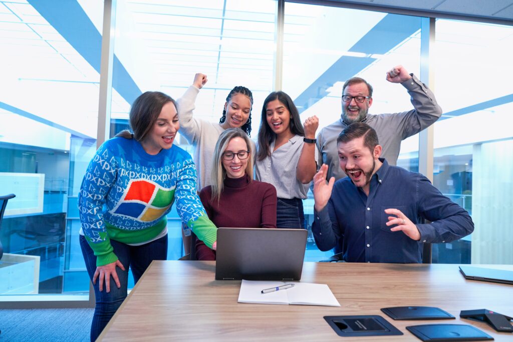 Happy office environment - Photo by Windows on Unsplash